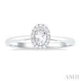 5x3 MM Oval Shape White Topaz and 1/20 Ctw Single Cut Diamond Halo Semi-Precious Ring in 10K White Gold